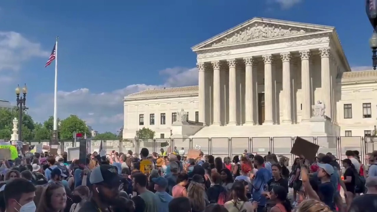 Pro-life and pro-choice activists gather outside the Supreme Court