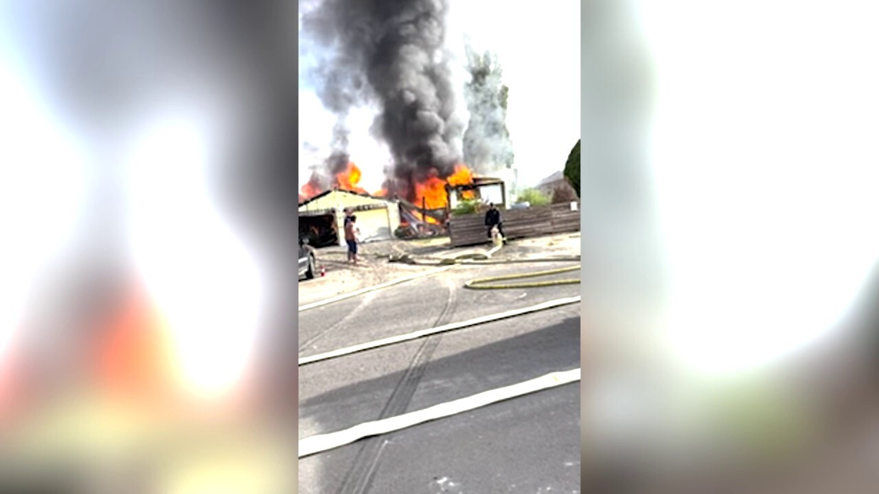 Firefighters try to extinguish raging inferno tearing through Washington state home