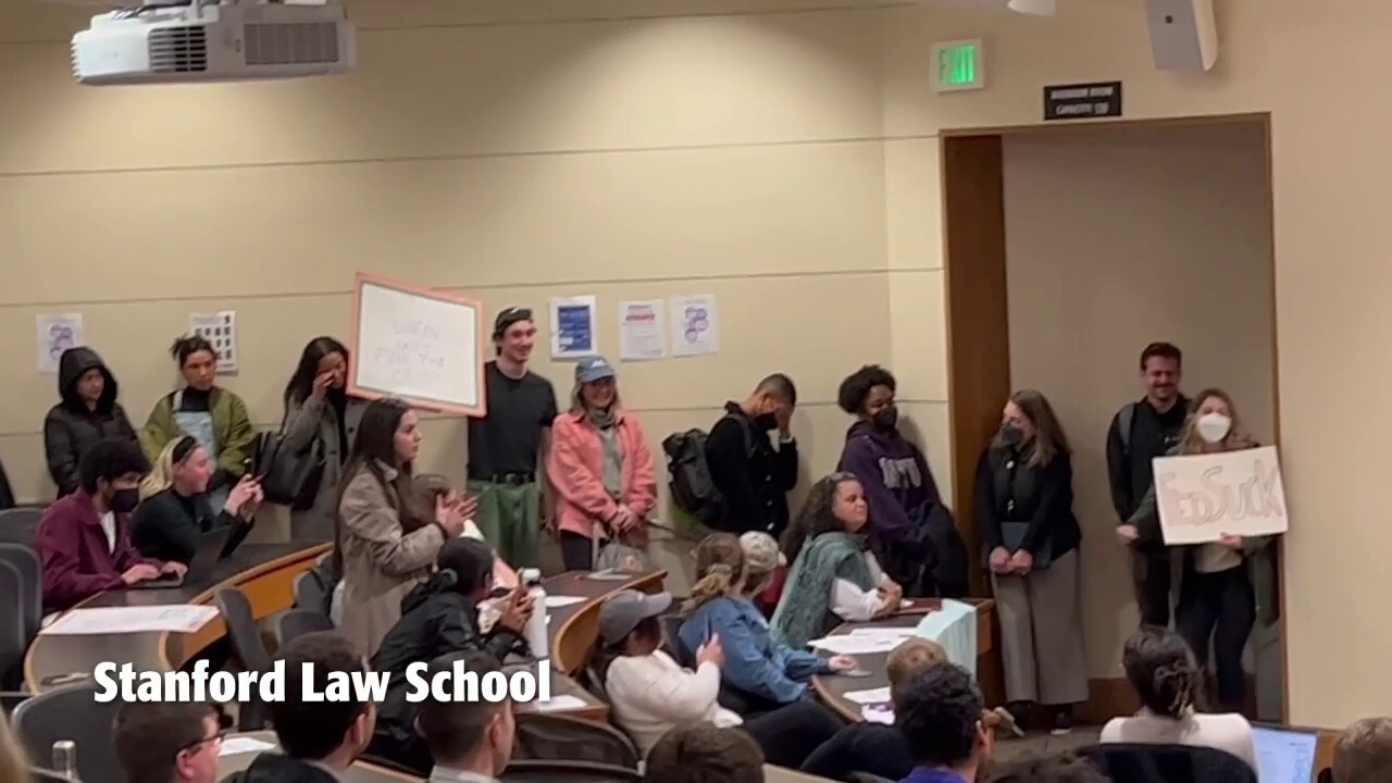 Stanford DEI dean looks on as protesters shout down Trump judge