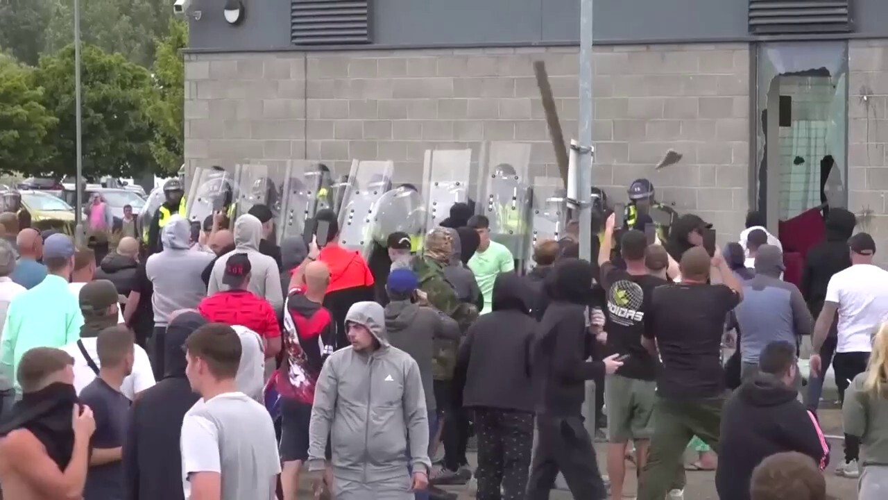 UK rioters toss chairs, bricks at police