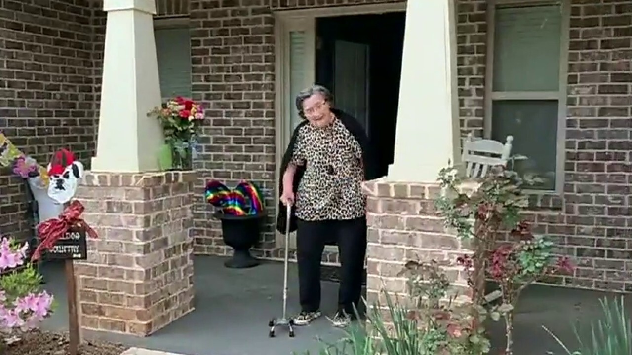 Neighborhood celebrates woman's 90th birthday from sidewalk