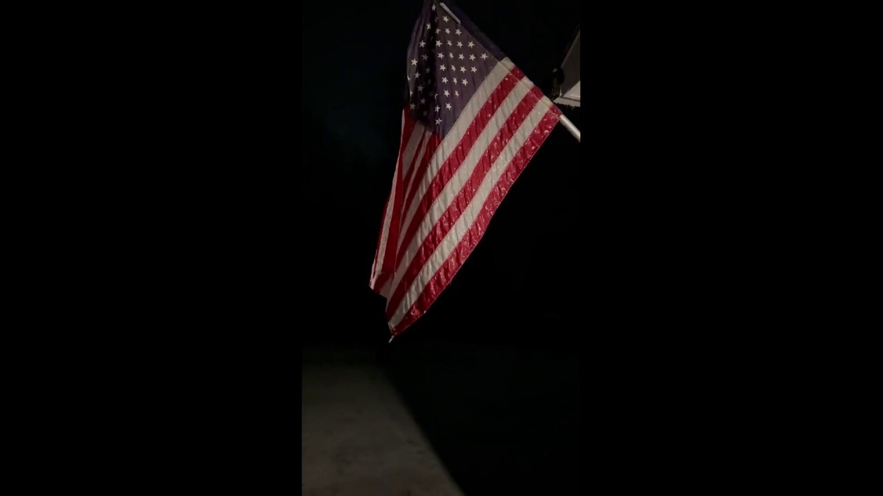 Proud American finds flag frozen outside