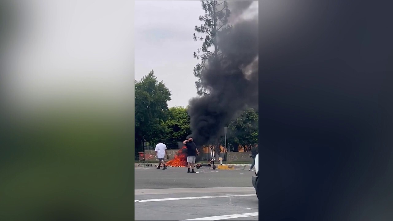California anti-ICE protester burns American flag