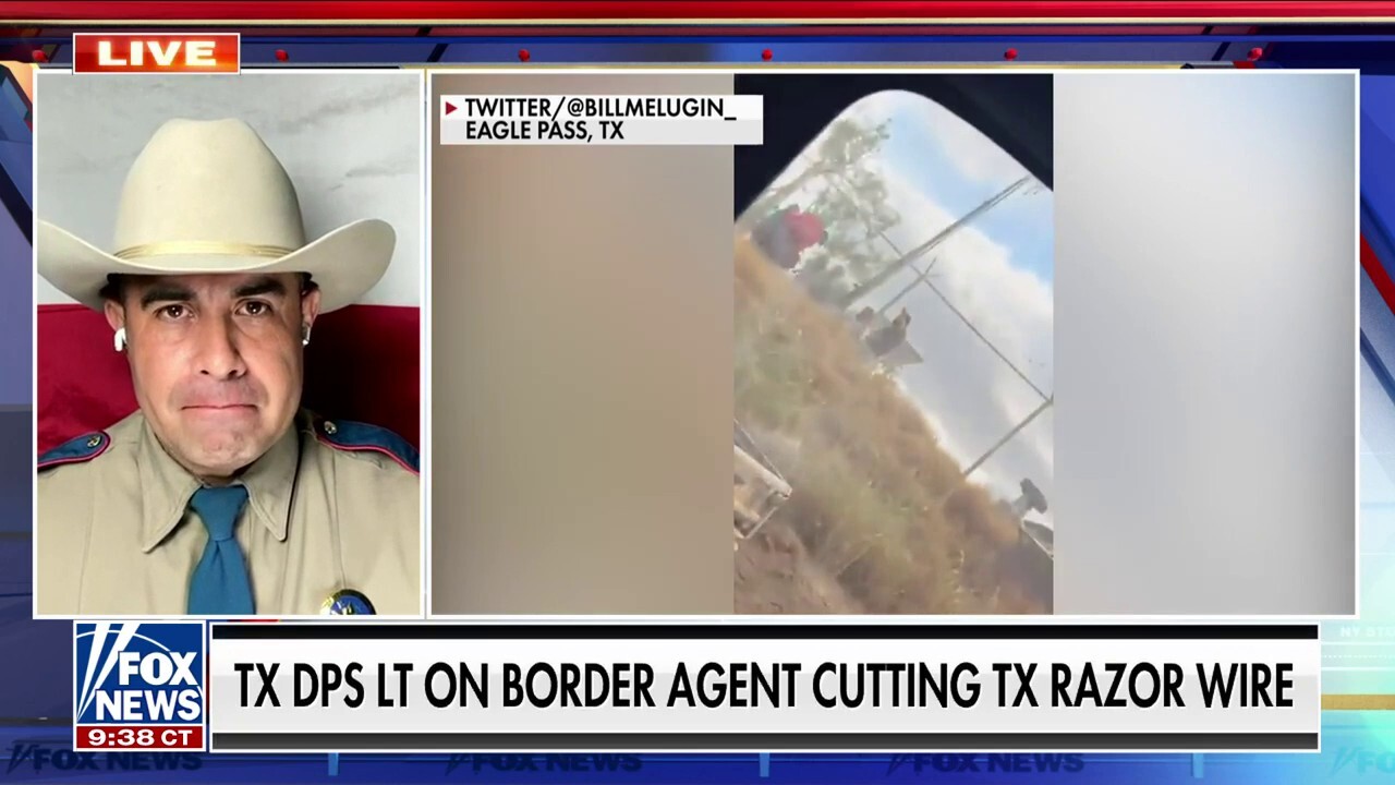 Border Patrol agent cutting razor wire to let in migrants