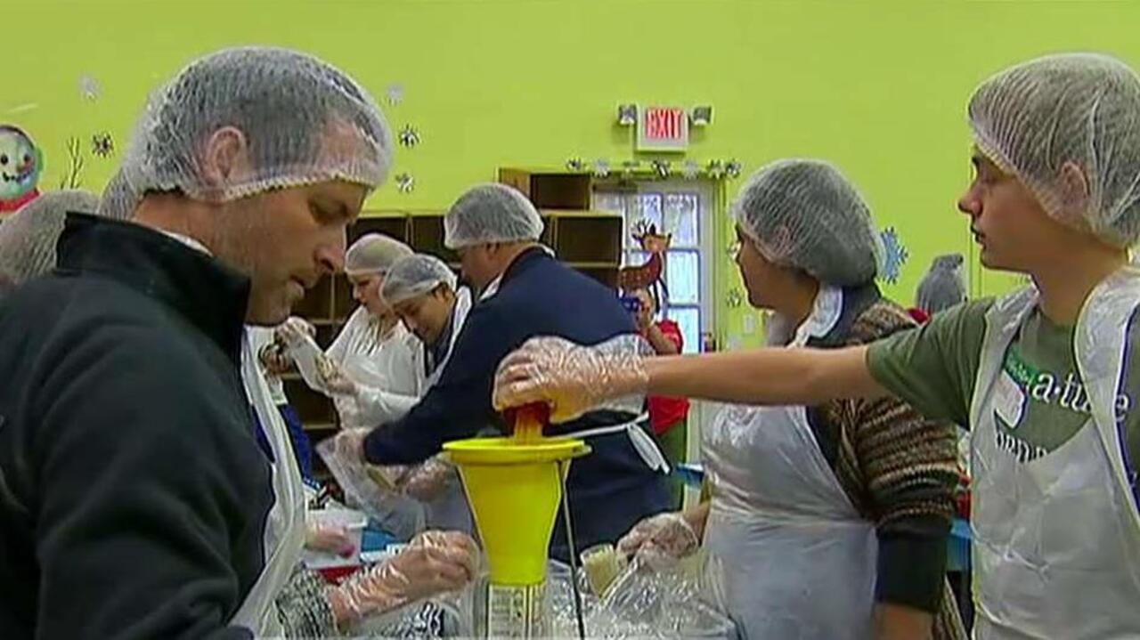 Volunteers prepare meals, gifts for families in need