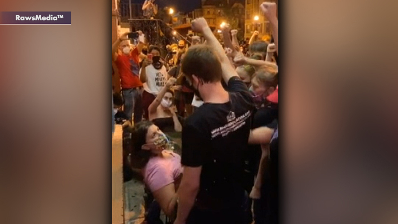 Protesters surround woman who wouldn't raise fist, chanting, 'White silence is violence'