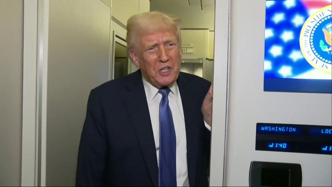 President Donald Trump speaks with reporters on Air Force One