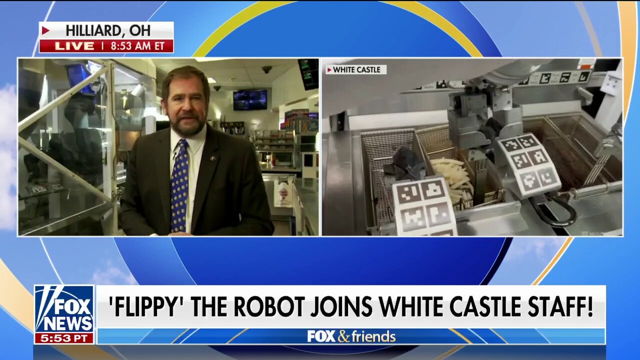 White Castle Vice President Jamie Richardson shows how 'Flippy' the robot flips burgers and drops fresh fries at 100 locations nationwide.