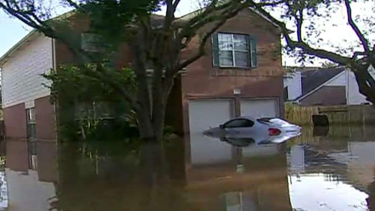 Houston tries to save some areas by flooding others 