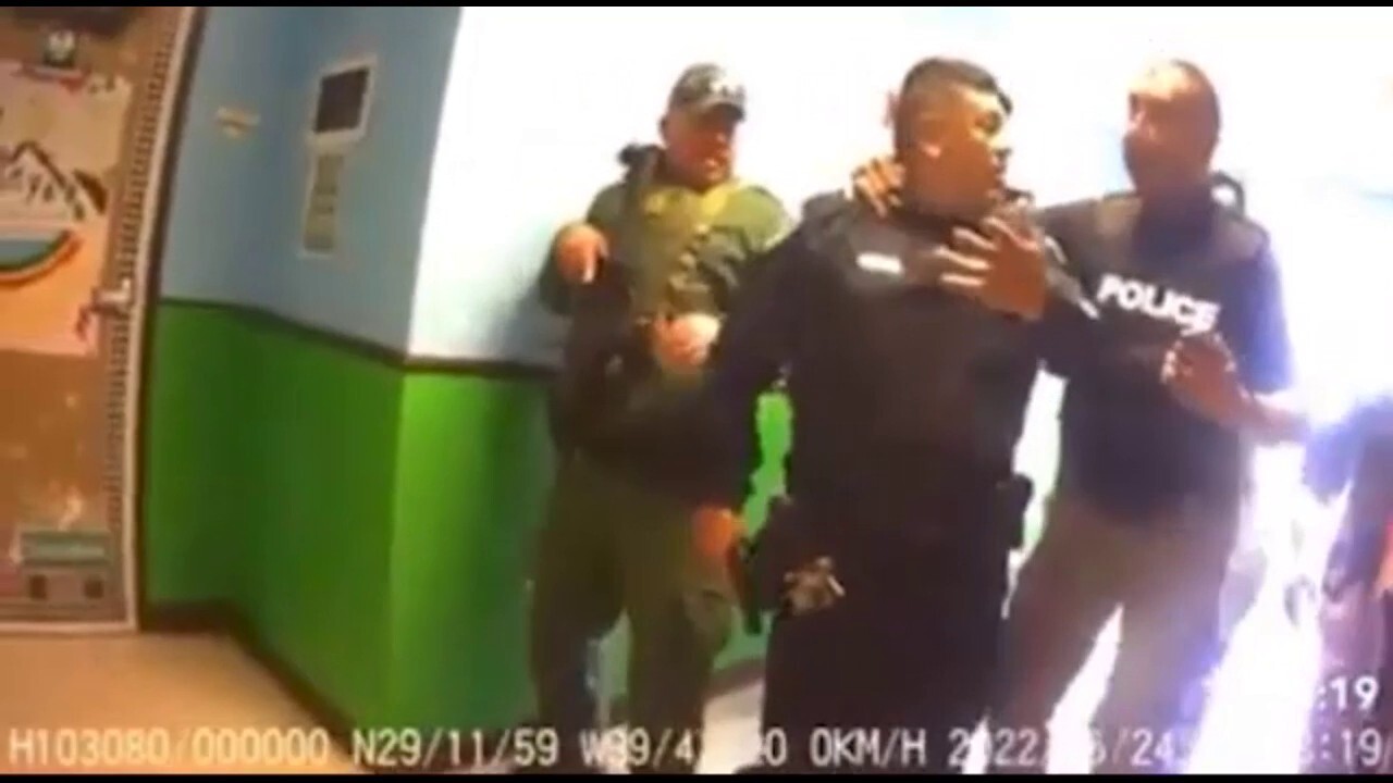 Uvalde bodycam video shows police officer holding back officer whose wife was in room with gunman