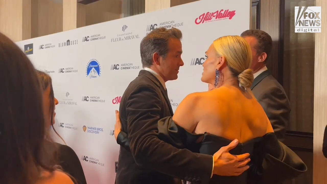 Ryan Reynolds hugs model Molly Sims at American Cinematheque Awards