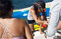 Off-duty Coast Guard Helicopter Pilot Rescues 2 People After Boat Sinks