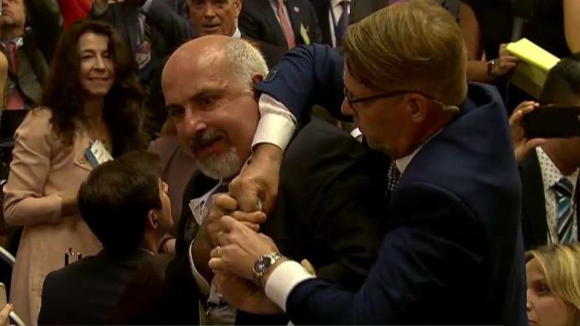 Protester removed from Trump-Putin news conference