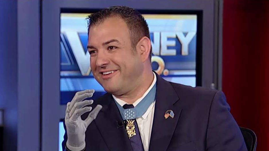 Medal of Honor recipient uses robotic prosthetic hand