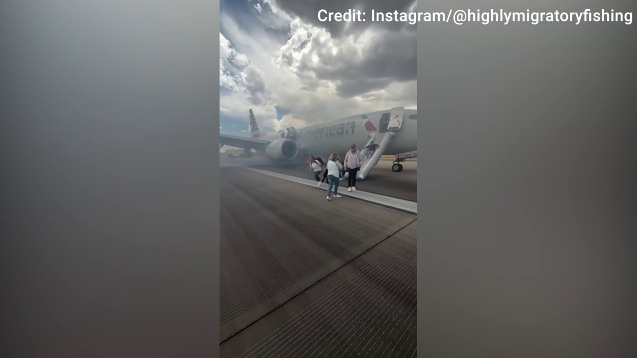 Passengers evacuate American Airlines aircraft after landing gear issue at Denver airport