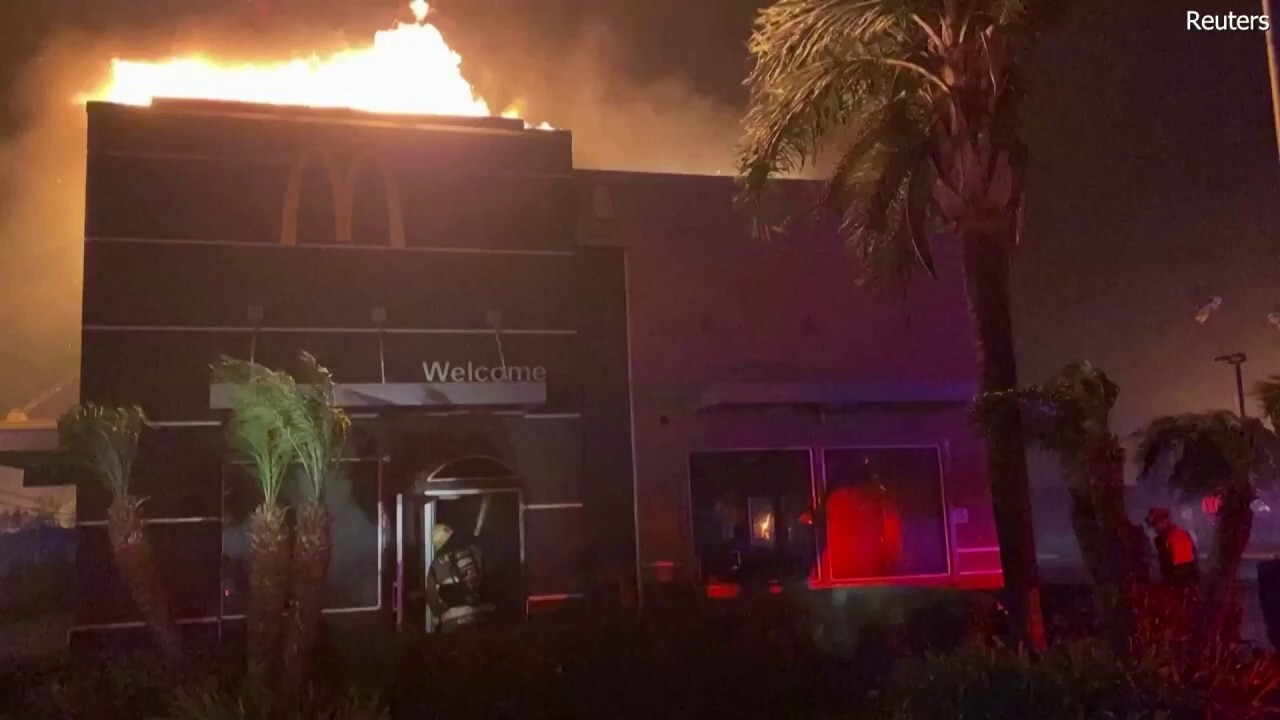 A McDonalds restaurant is seen burning while firefighters work to combat the blaze in Pasadena, California, as the Eaton Fire rages. (Reuters)