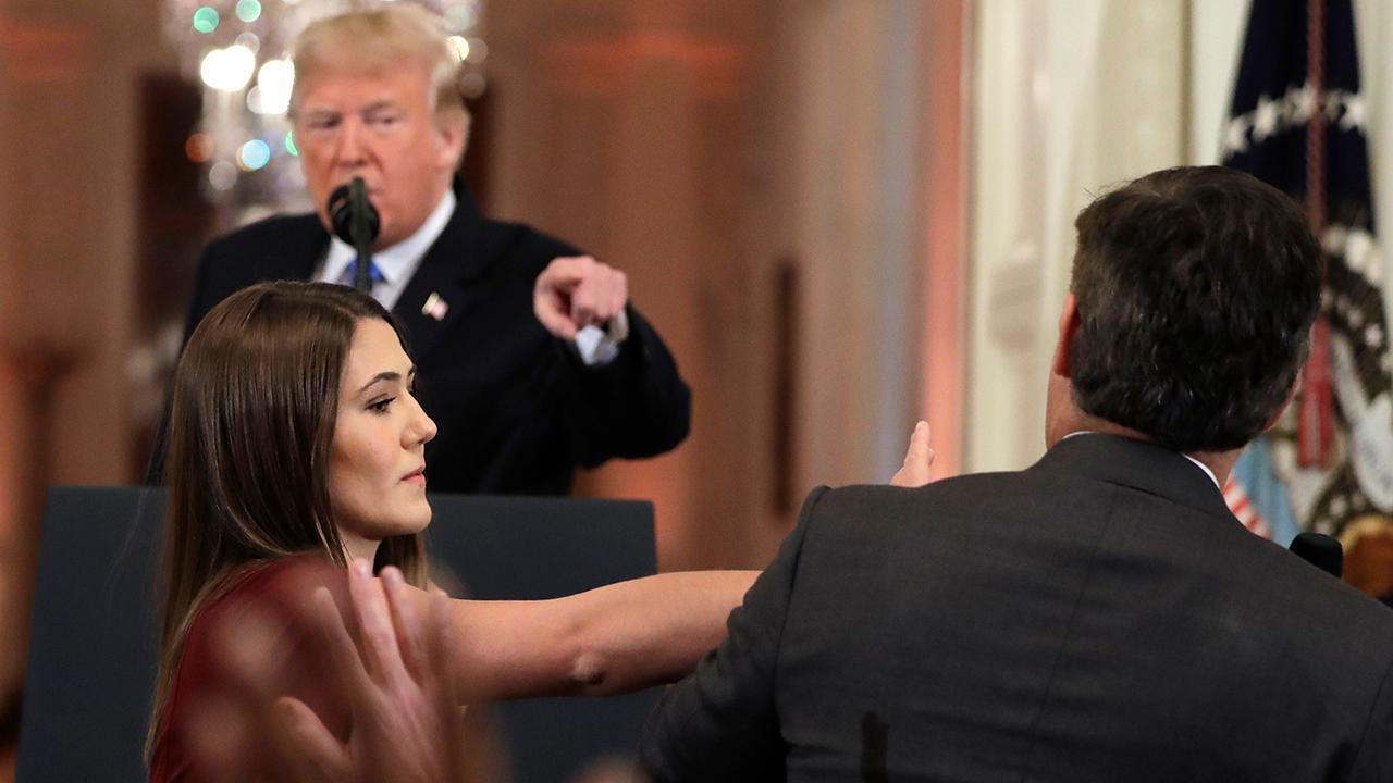 CNN’s Jim Acosta refuses to give up microphone during exchange with Trump