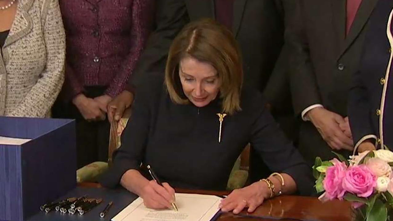 Nancy Pelosi signs spending bill 