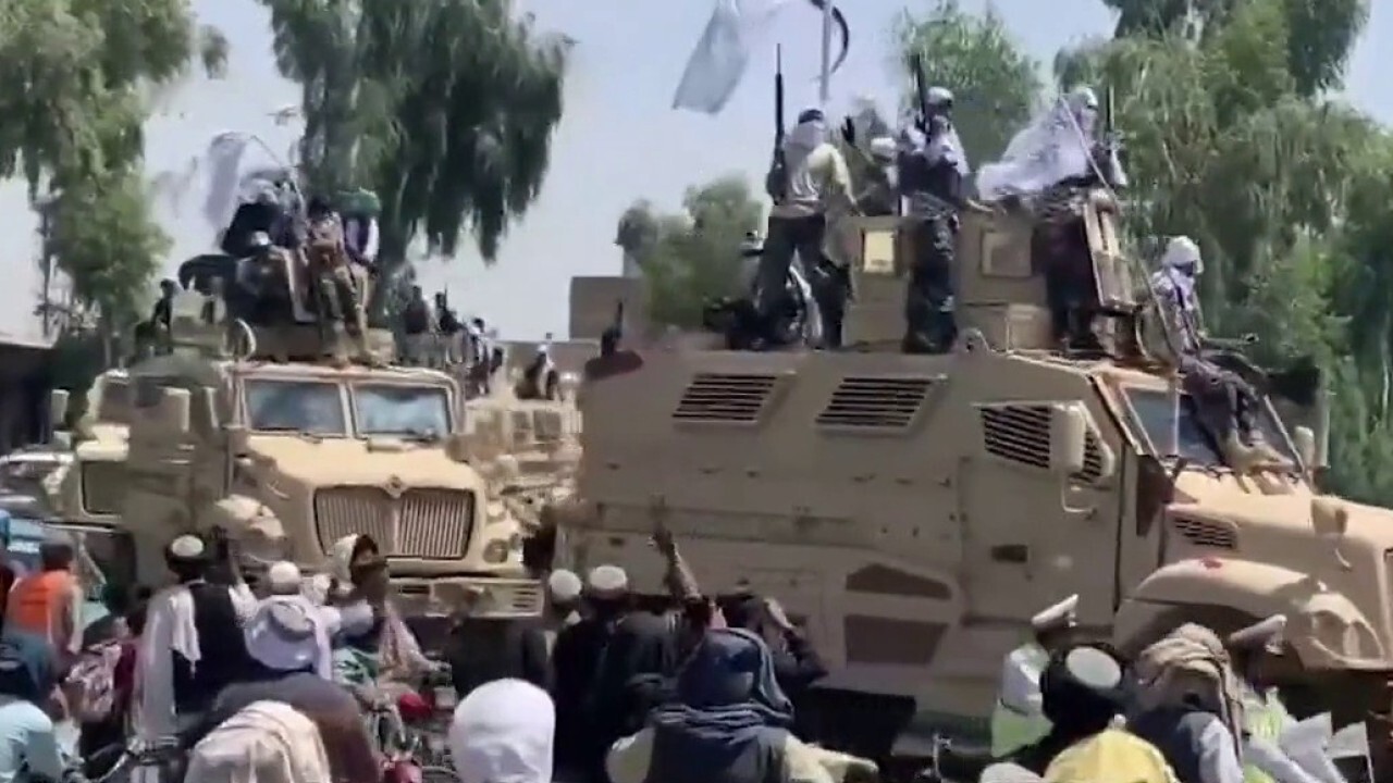 Taliban throws military parade flaunting US trucks, guns and a helicopter