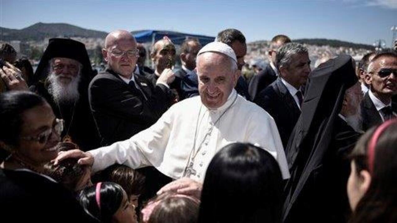 Pope returns to Vatican with migrants