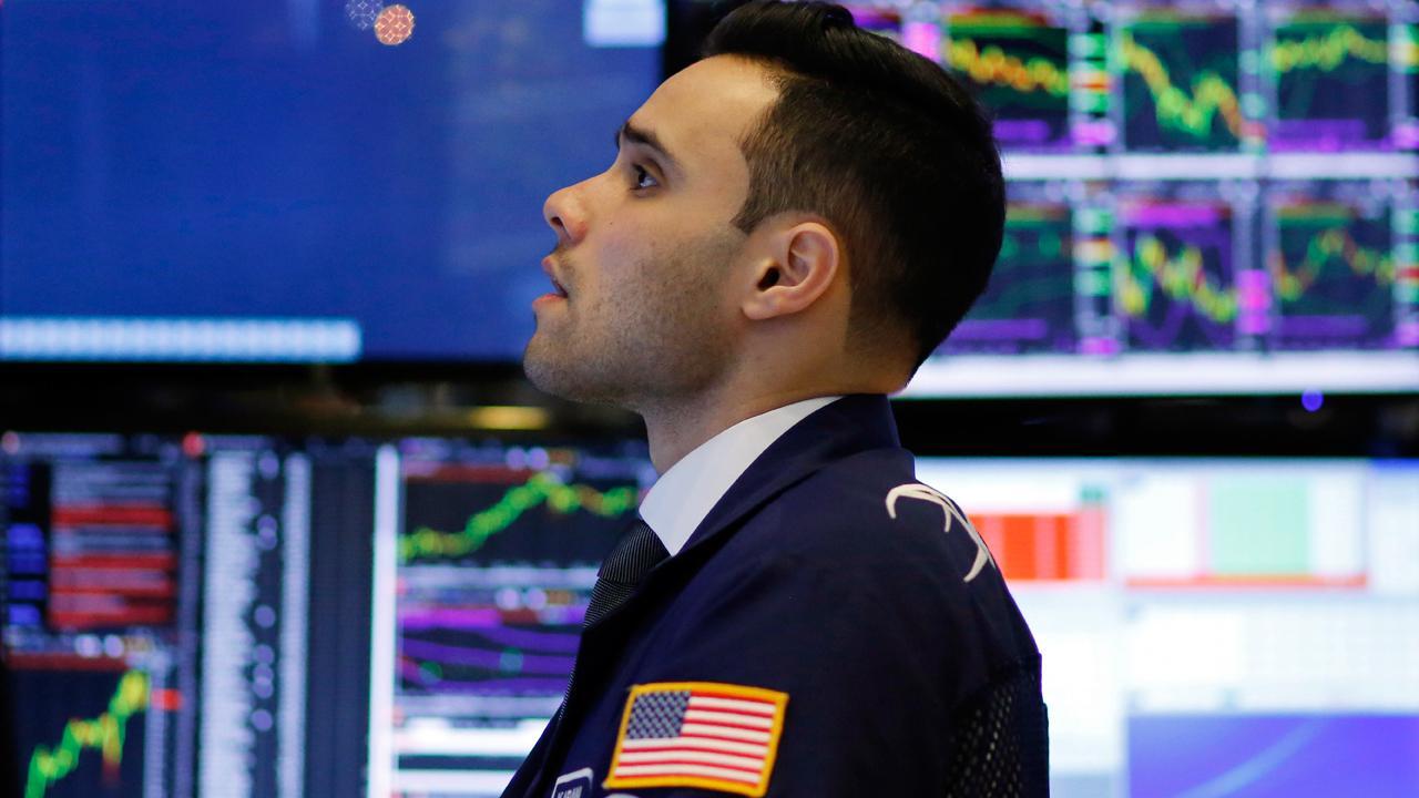 Dow closes at record after Fed raises rates