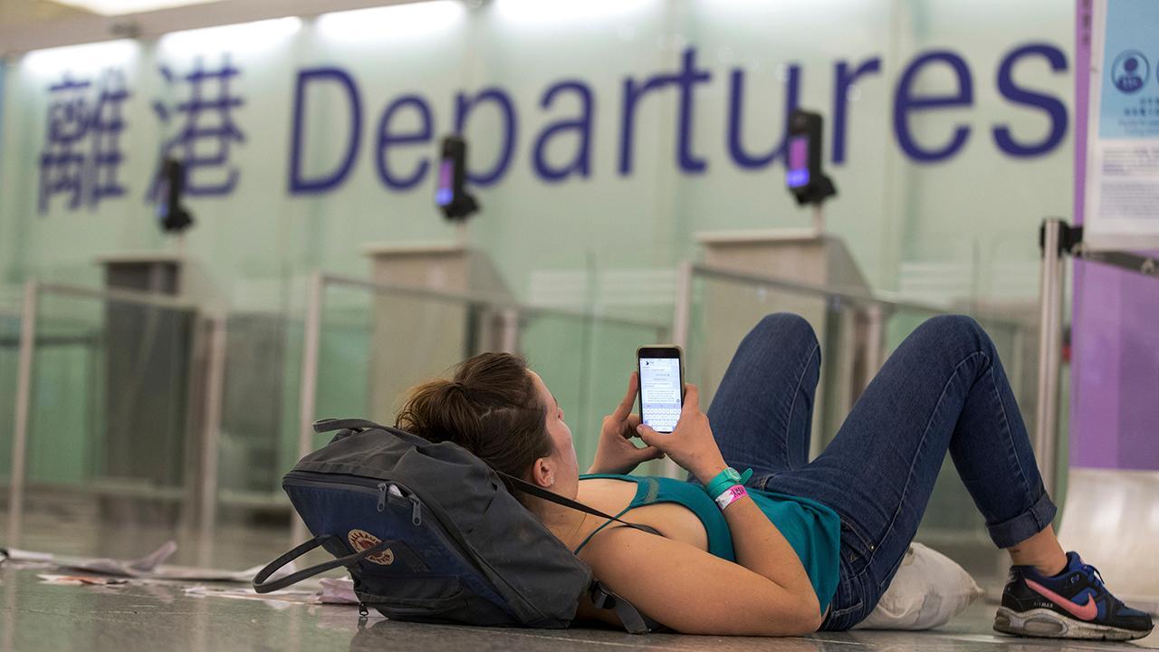 China trade war: Tough talk from protesters shut down Hong Kong airport