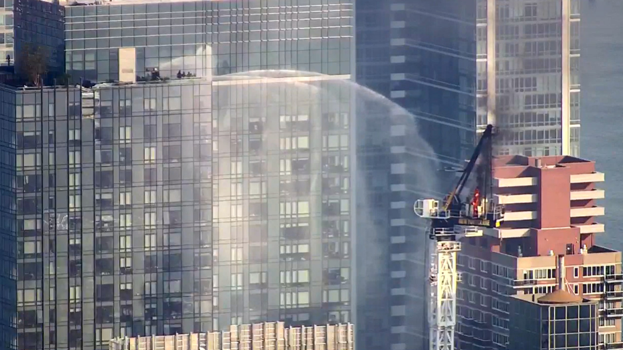 WATCH LIVE: Crane crashes on high-rise building igniting flames as thick black smoke fills the air