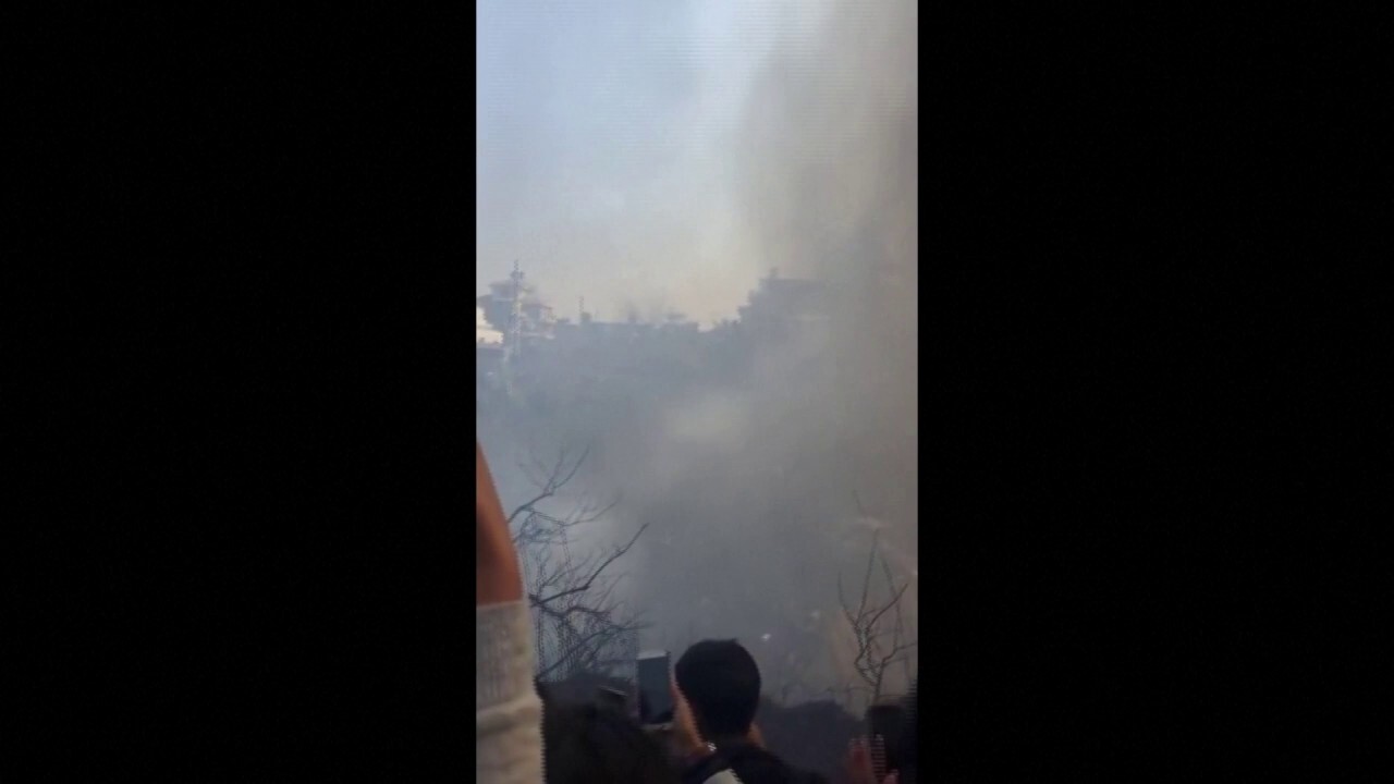 Bystanders filmed the aftermath of a plane crash that killed at least 68 people in Nepal on Sunday. (Reuters)